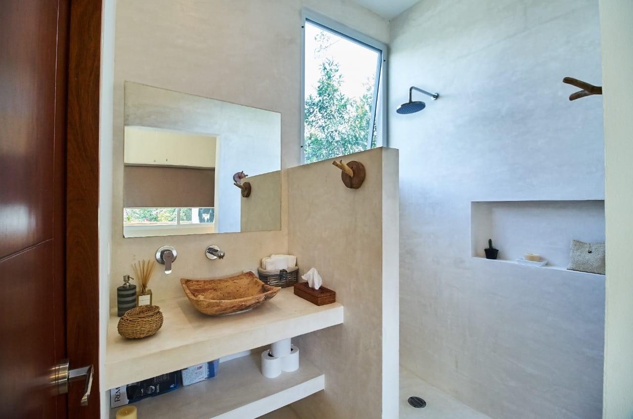 Concrete bathroom with stone vessel sink