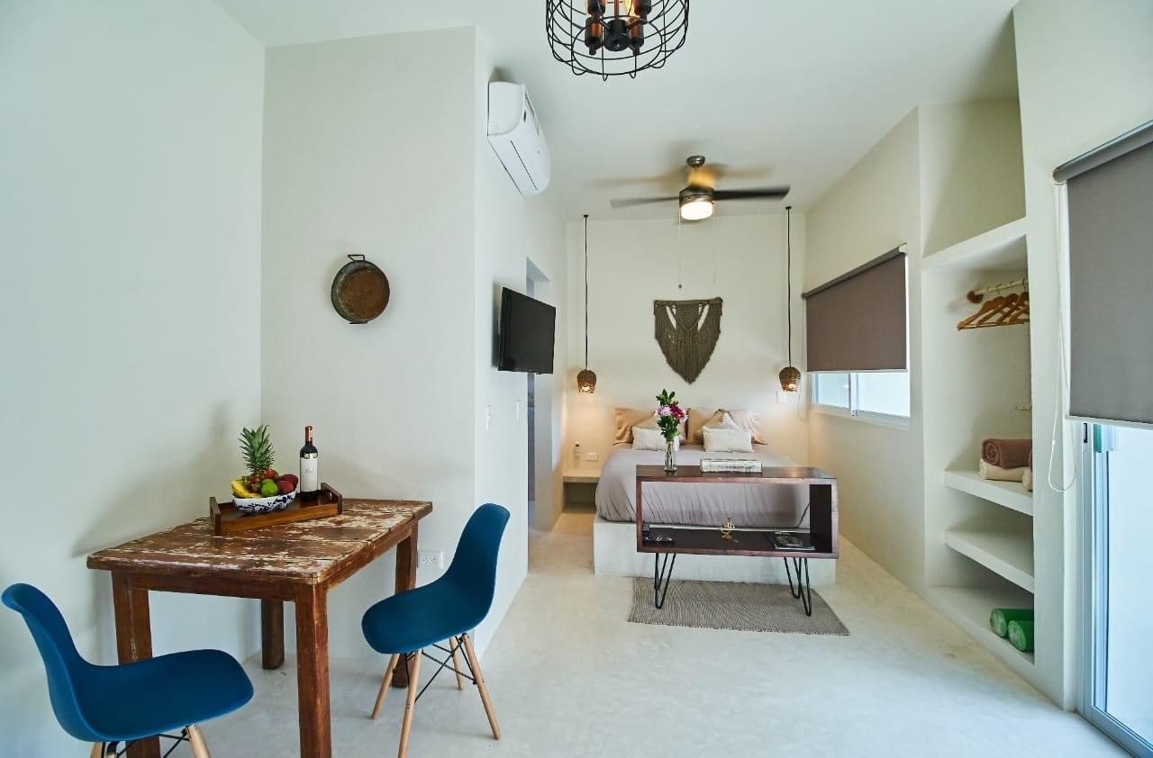 Full studio view with dining nook and bed